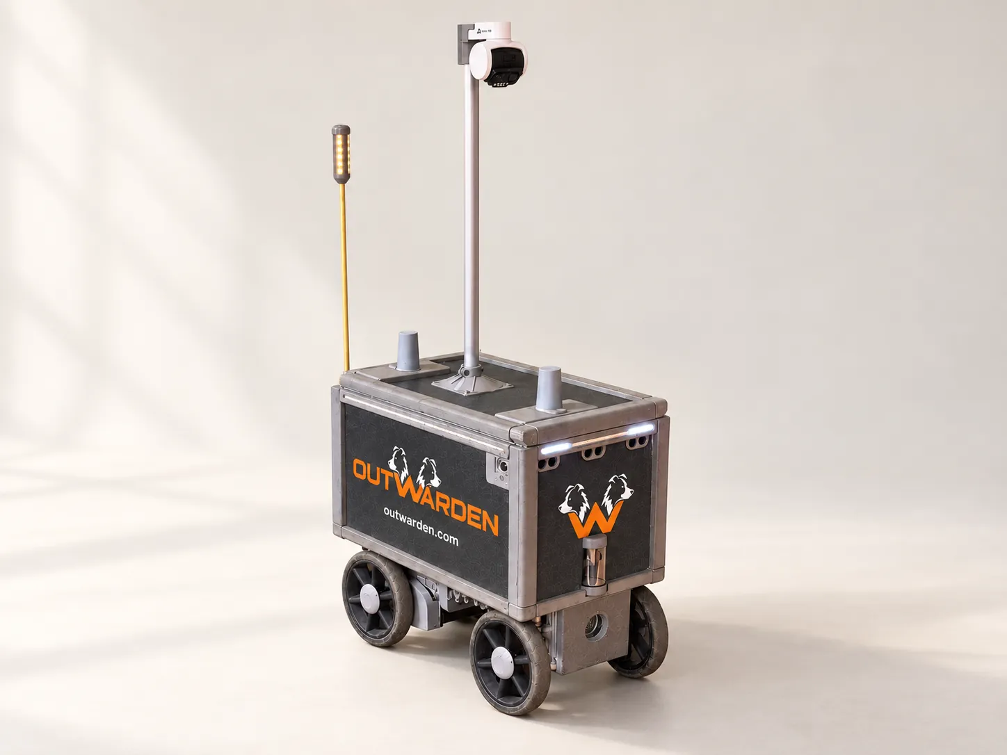 Outwarden four-wheel security robot with a tall camera mast, charcoal body panels and orange branding