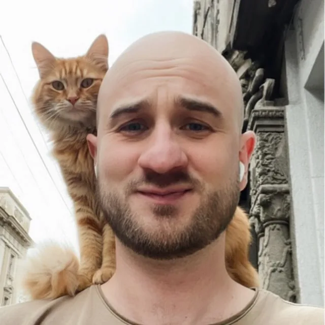 Teodor, co-founder and CEO of Outwarden, with a ginger cat on his shoulder
